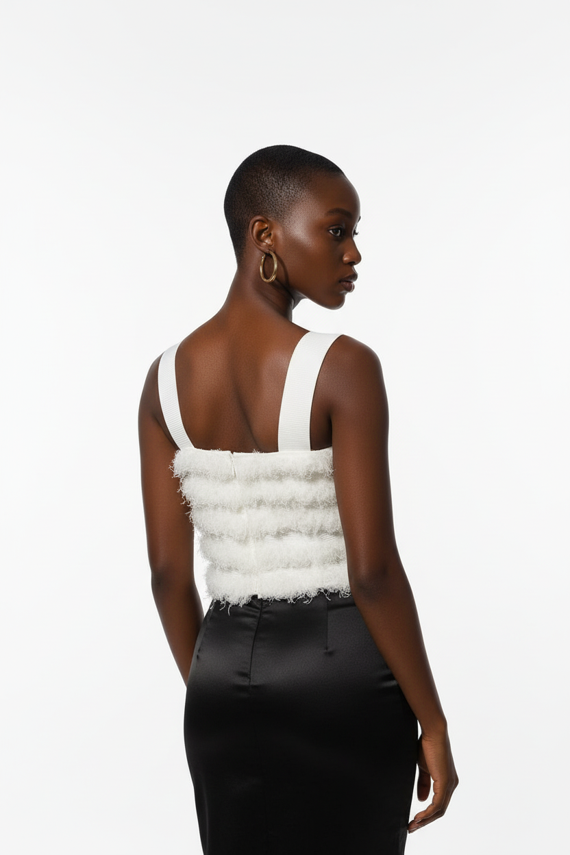 Model in white fringe top - back view